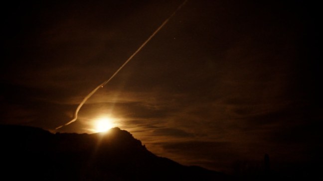 Moonrise with contrails over Pass Mountain